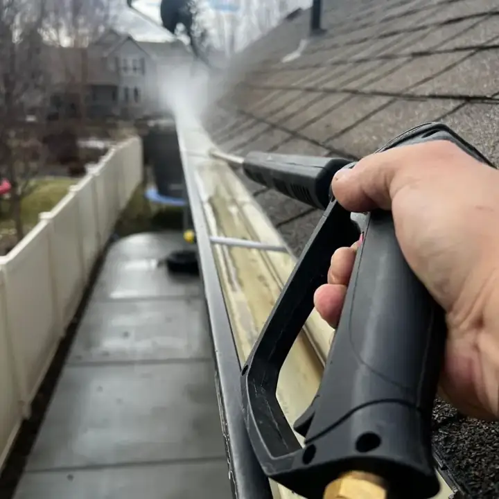 Pressure washing a residential gutter